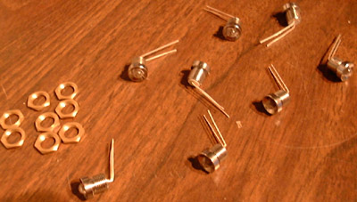 LED holders and mounting nuts laid out on a table